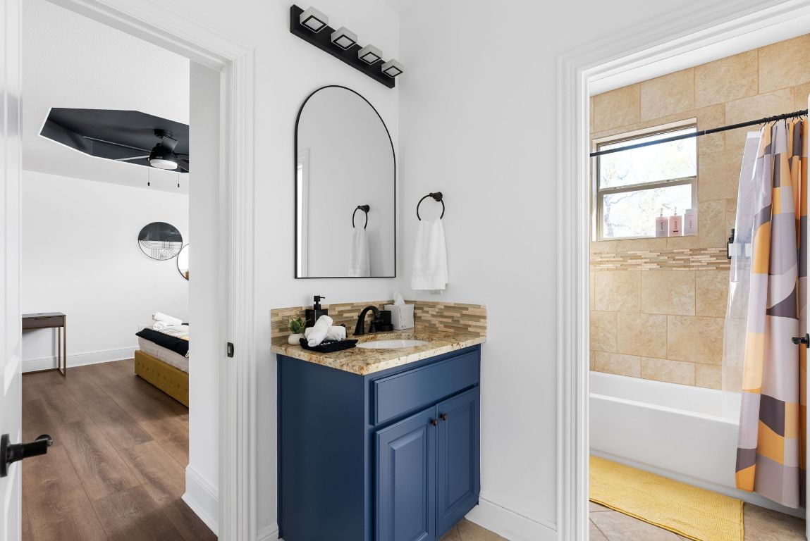 1116 Terjo Lane Austin, TX 78732 - Photo 24 of 40 a bathroom with a double vanity sink a mirror and shower