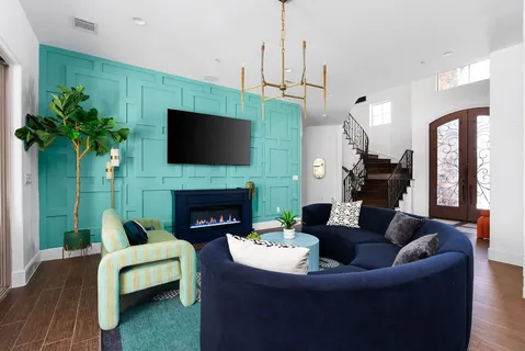a living room with furniture a fireplace and a flat screen tv