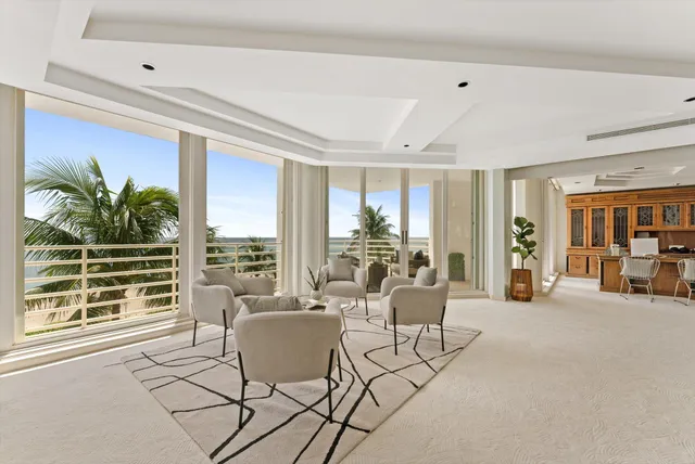 a living room with furniture and large windows