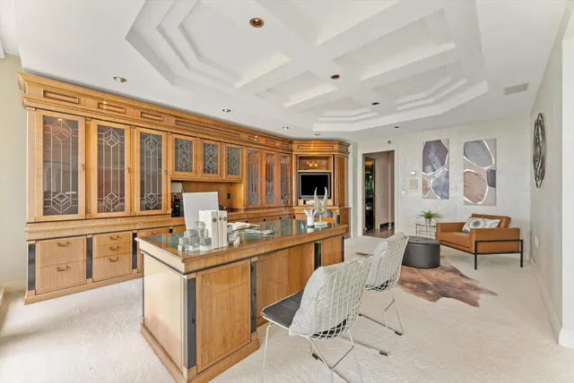 a room with stainless steel appliances kitchen island granite countertop a sink and cabinets