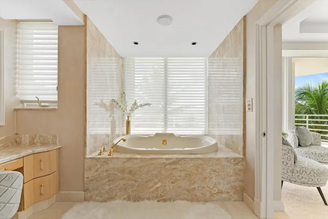 a bathroom with a tub sink and mirror
