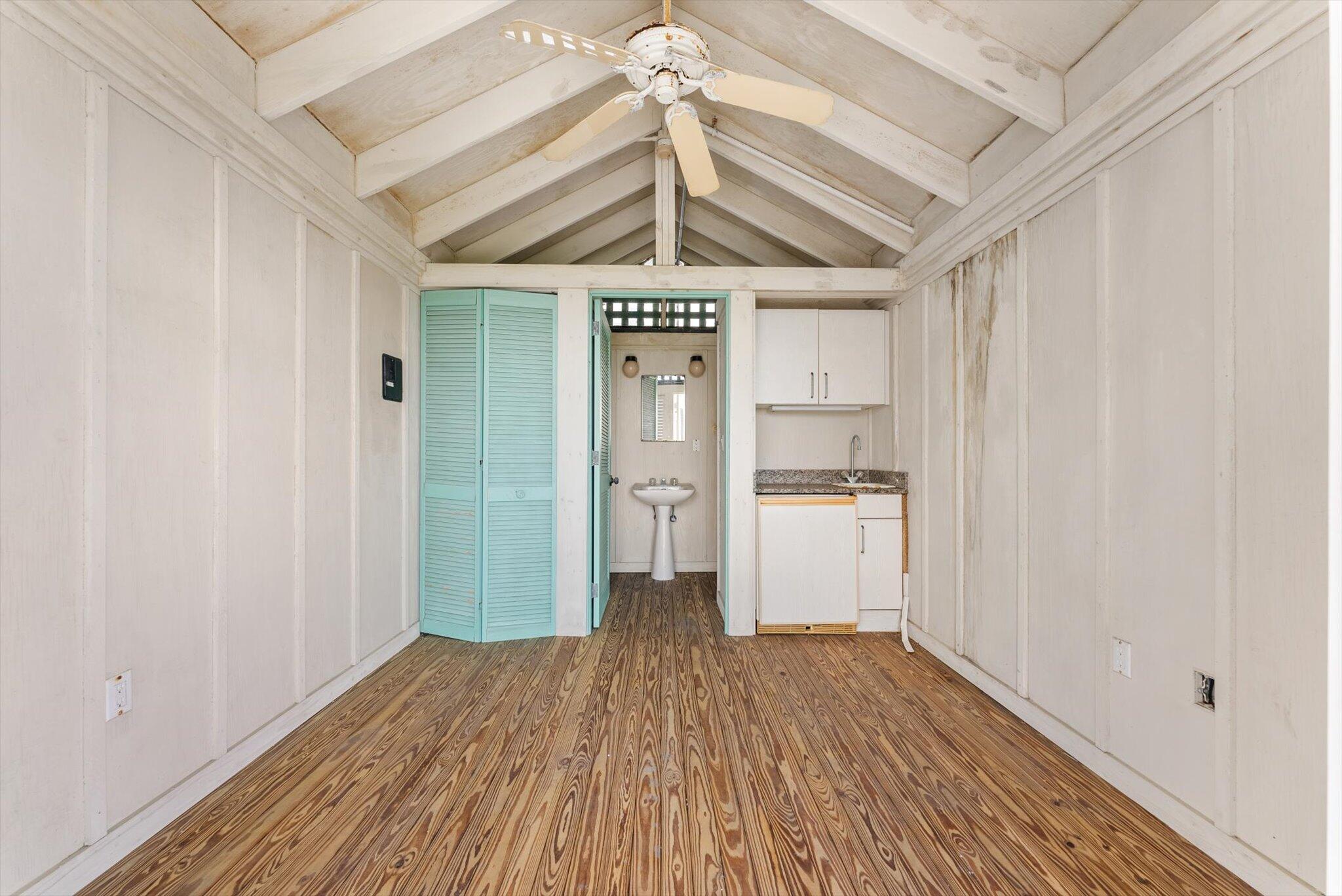 800 South Ocean Boulevard, Unit 303 Boca Raton, FL 33432 - Photo 30 of 49 a view of a hallway with wooden floor and a ceiling fan