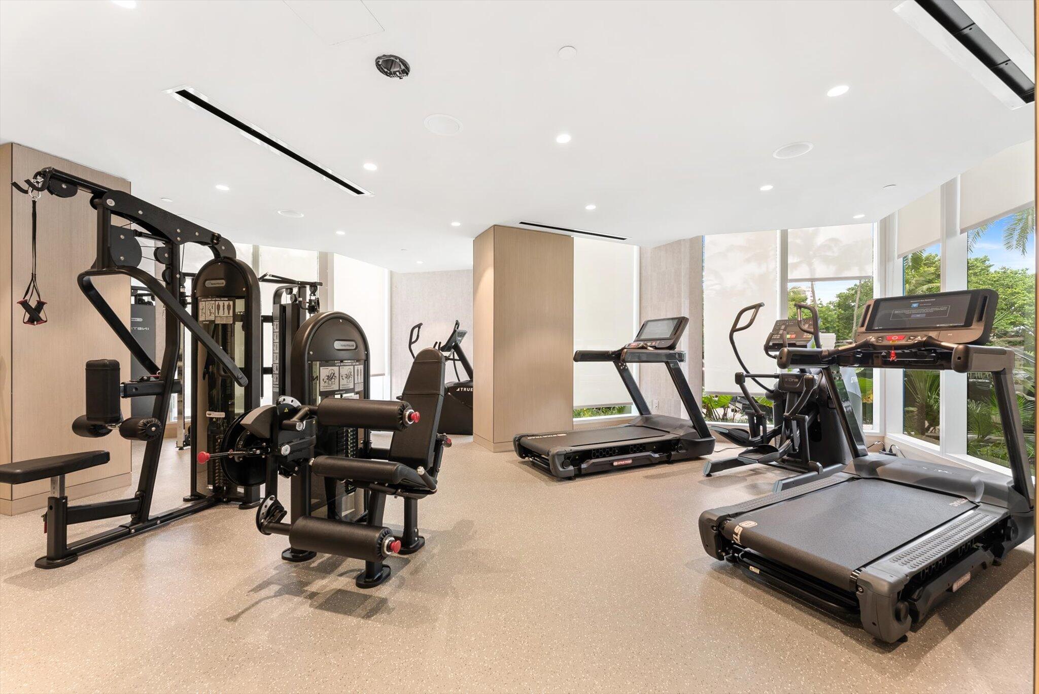 800 South Ocean Boulevard, Unit 303 Boca Raton, FL 33432 - Photo 36 of 49 a room with gym equipment and windows