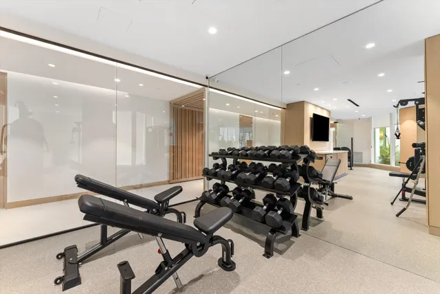 a room with gym equipment and a view of living room