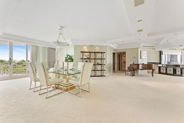 a view of a livingroom with furniture and a floor to ceiling window