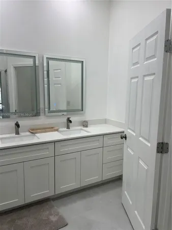 a bathroom with 2 sink and a mirror