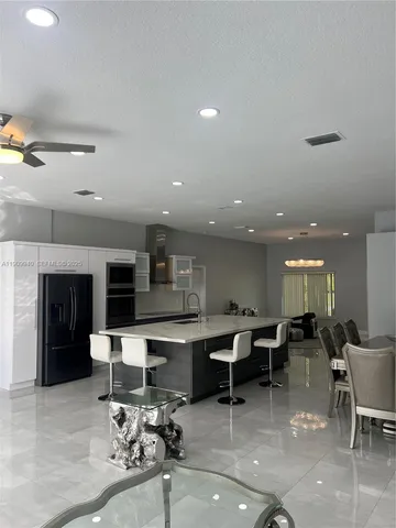 a living room with furniture a dining table and chairs