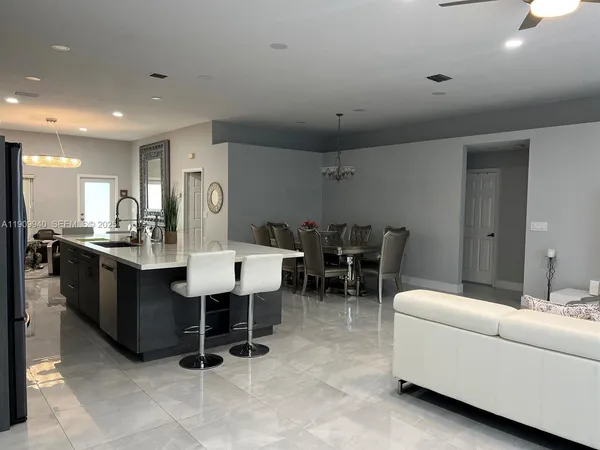 a living room with furniture a dining table and chairs