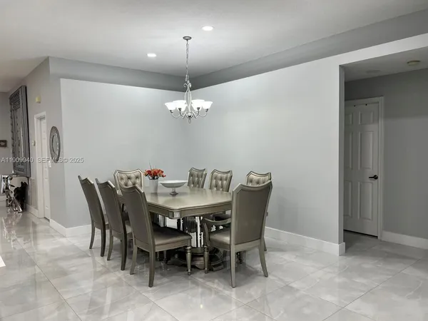 a view of a dining room with furniture and chandelier