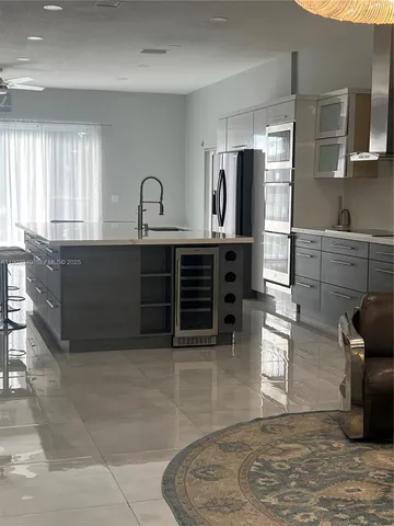 a bedroom with a bed next to a larger window