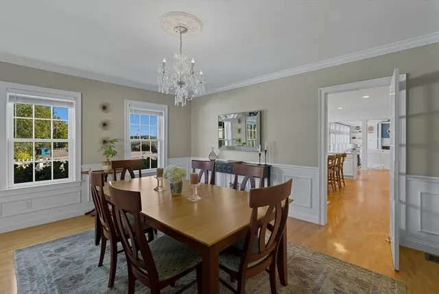 a bedroom with a bed and walk in closet with wooden floor