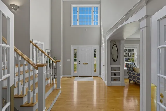 a bedroom with a bed and next to a window