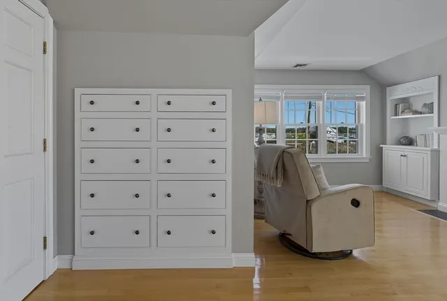 a bedroom with furniture and baby crib
