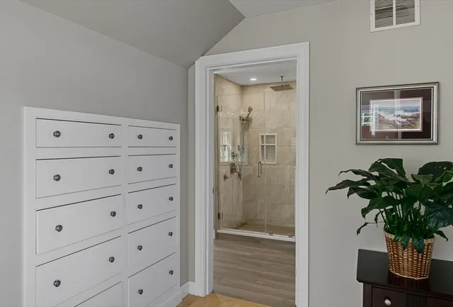 a bathroom with a granite countertop sink a toilet and a large mirror