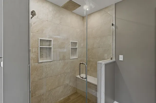 a view of a table and chairs under an umbrella in patio with a lake view