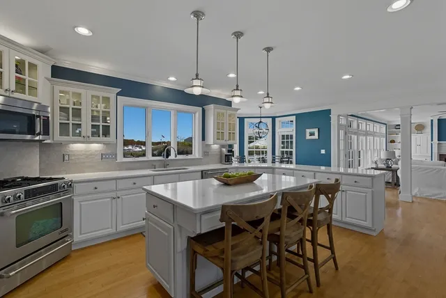 a living room with dining table and a large window