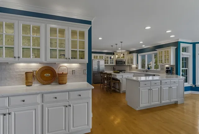 a living room with furniture a large window and a fireplace