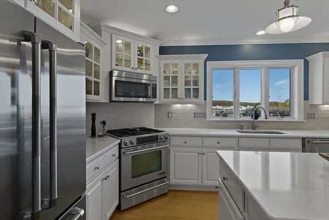 a view of a livingroom with wooden floor and a fireplace
