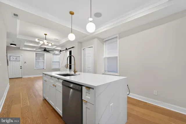 a kitchen with a sink and chandelier
