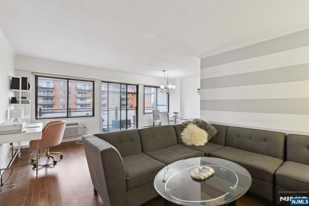 125 Prospect Avenue, Unit 17G Hackensack, NJ 07601 - Photo 2 of 20 a living room with furniture and wooden floor