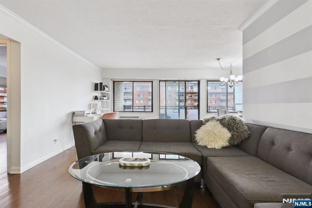 125 Prospect Avenue, Unit 17G Hackensack, NJ 07601 - Photo 3 of 20 a living room with furniture and a large window