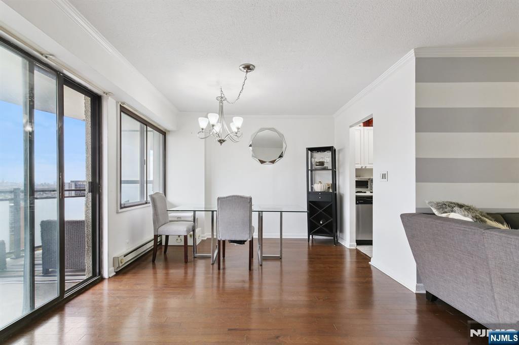 125 Prospect Avenue, Unit 17G Hackensack, NJ 07601 - Photo 5 of 20 a view of a dining room with furniture and wooden floor
