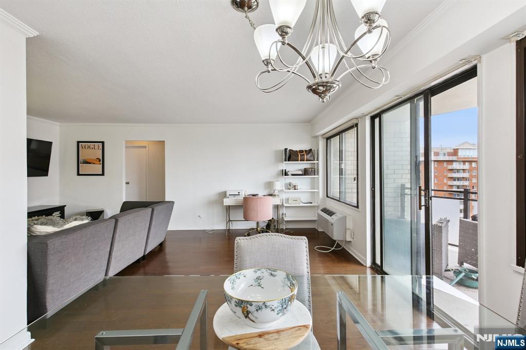 125 Prospect Avenue, Unit 17G Hackensack, NJ 07601 - Photo 9 of 20 a living room with furniture and a chandelier
