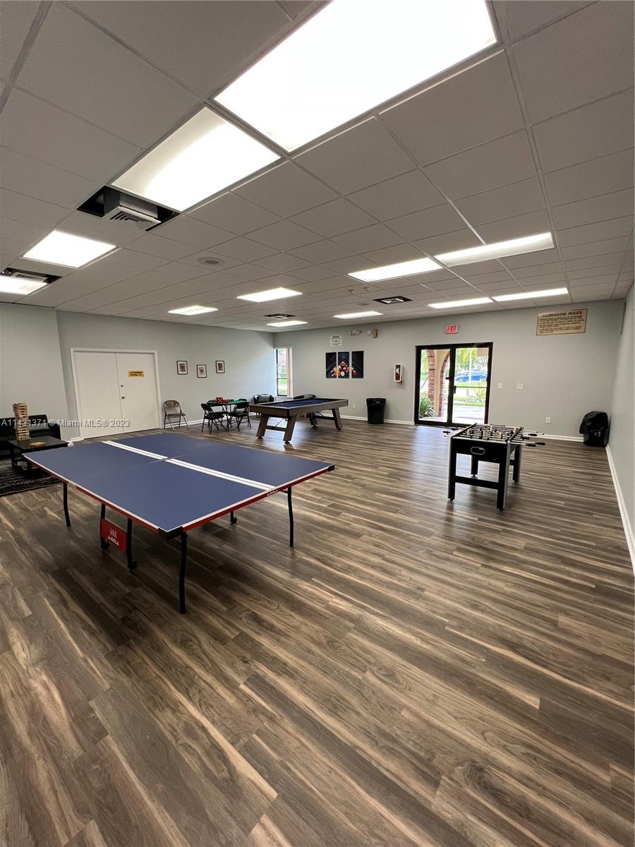 23314 Southwest 54th Way, Unit E Boca Raton, FL 33433 - Photo 11 of 69 a living room with furniture a table and wooden floor