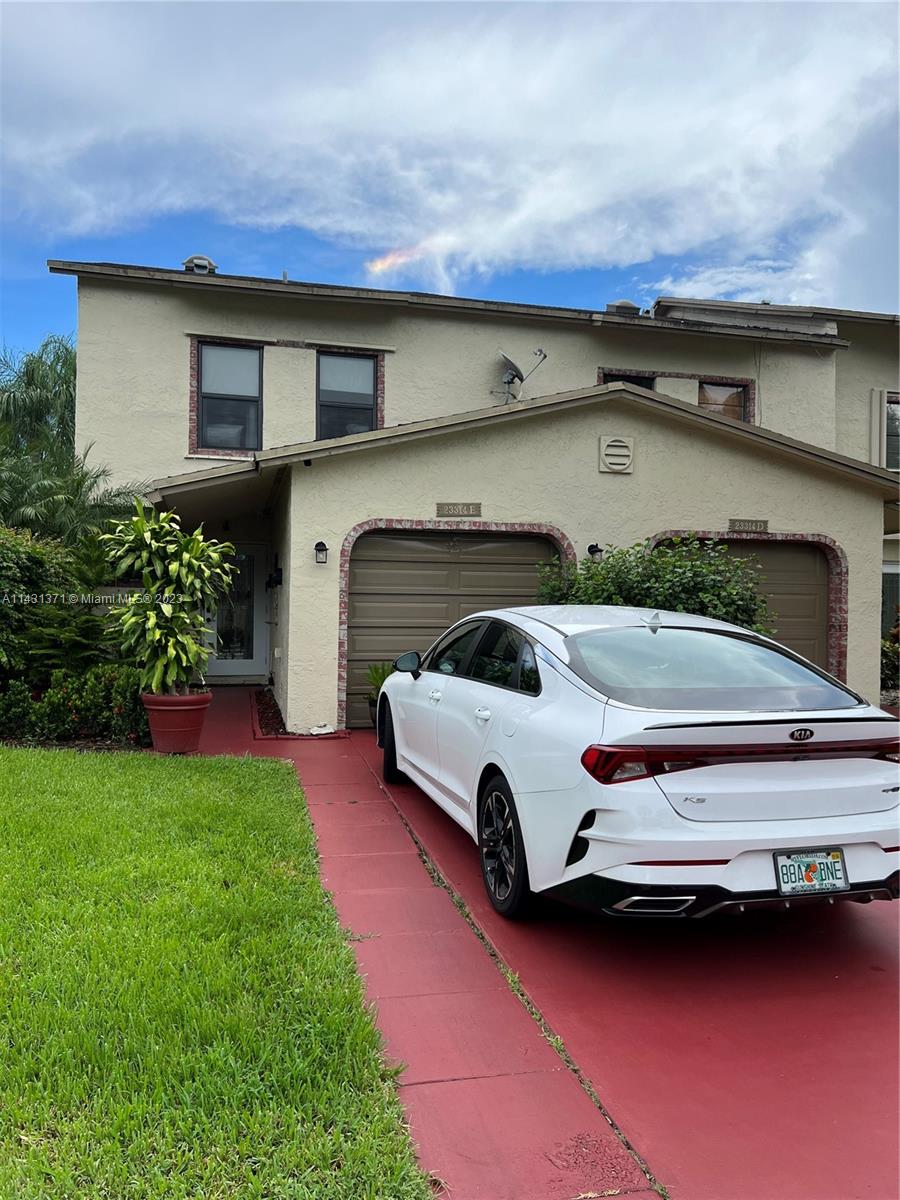 23314 Southwest 54th Way, Unit E Boca Raton, FL 33433 - Photo 17 of 69 a car parked in front of white house