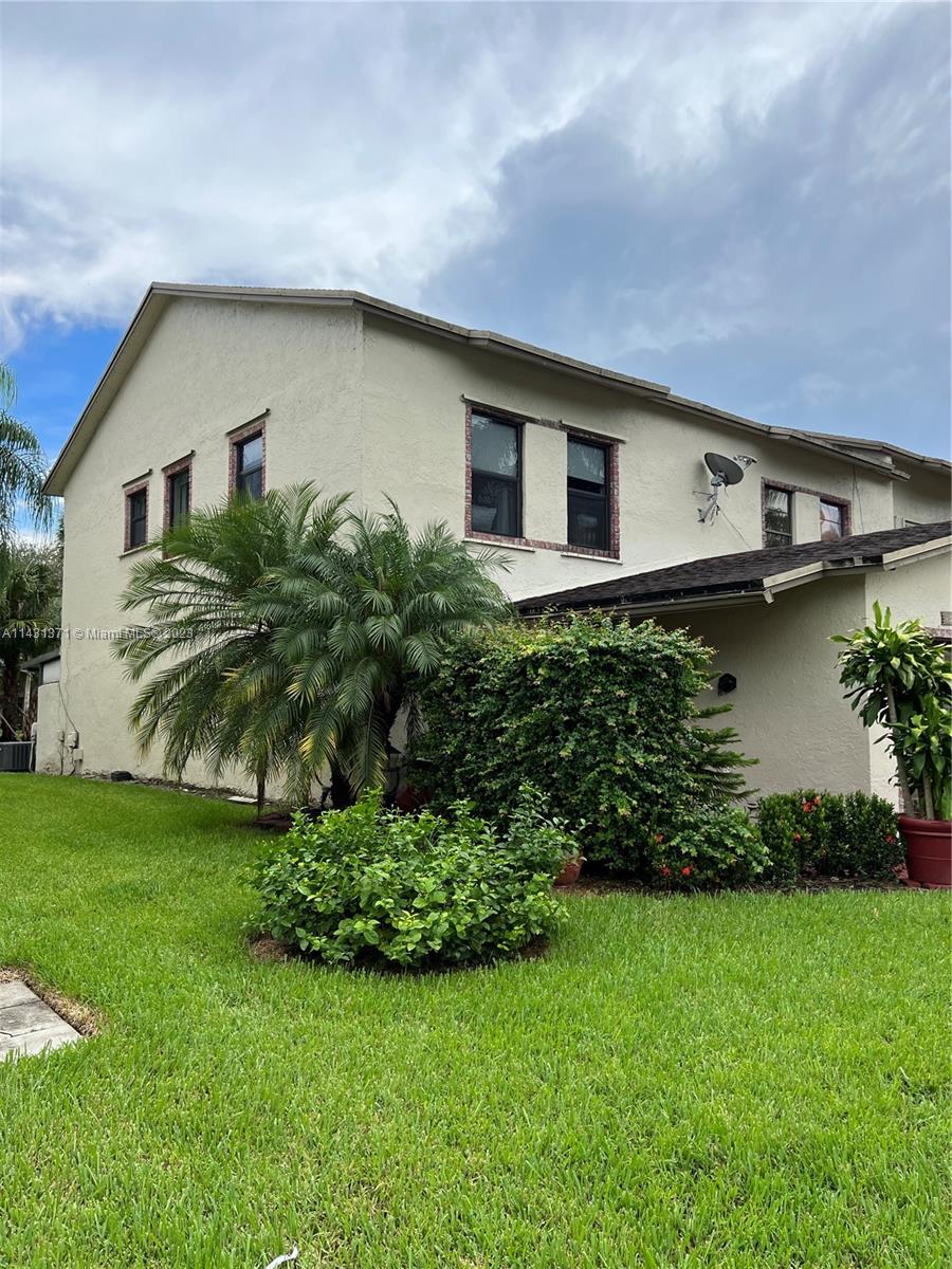 23314 Southwest 54th Way, Unit E Boca Raton, FL 33433 - Photo 18 of 69 a front view of a house with garden