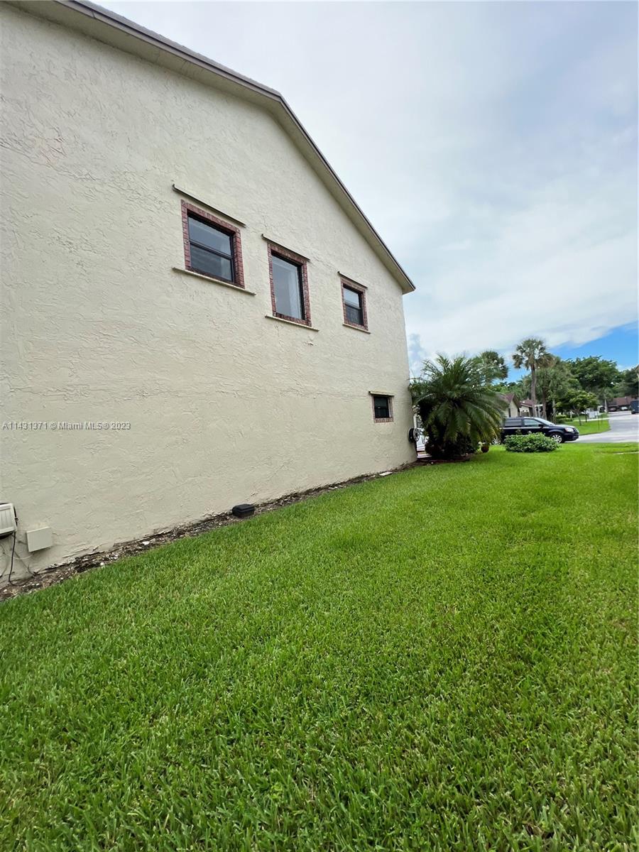 23314 Southwest 54th Way, Unit E Boca Raton, FL 33433 - Photo 19 of 69 a front view of a house with garden