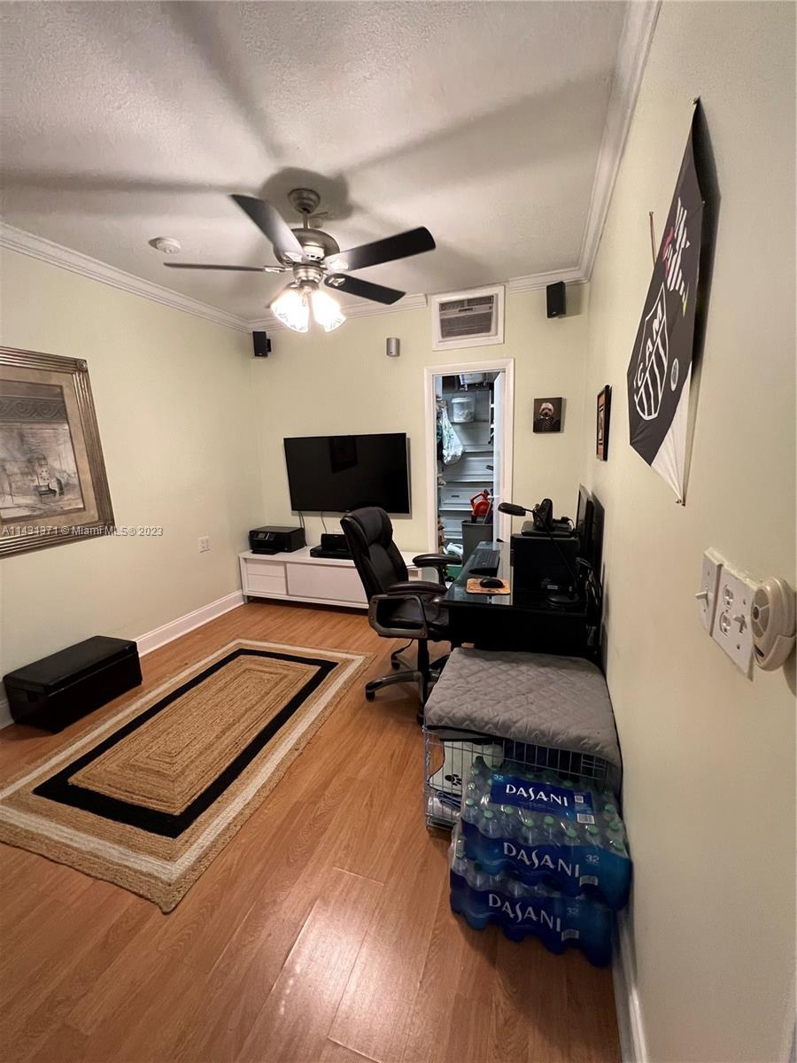 23314 Southwest 54th Way, Unit E Boca Raton, FL 33433 - Photo 26 of 69 a living room with furniture a fireplace and a flat screen tv