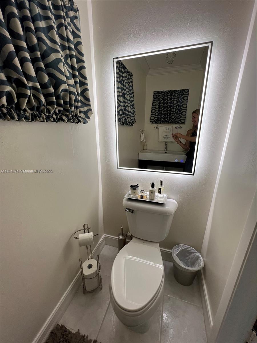 23314 Southwest 54th Way, Unit E Boca Raton, FL 33433 - Photo 30 of 69 a bathroom with a toilet sink and mirror