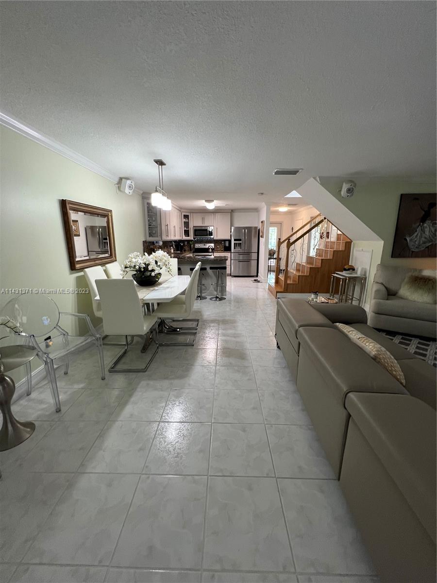23314 Southwest 54th Way, Unit E Boca Raton, FL 33433 - Photo 43 of 69 a living room with couches and a kitchen view
