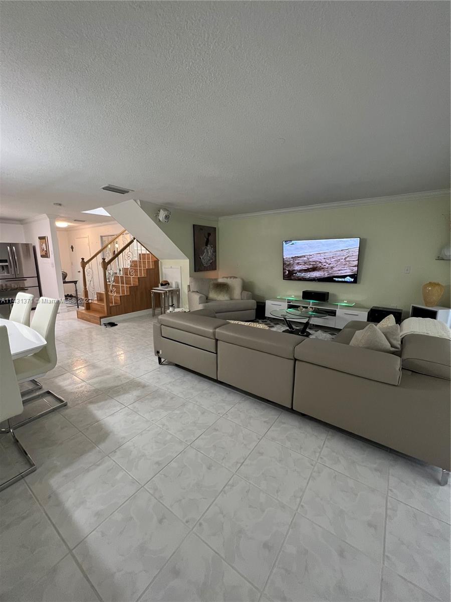 23314 Southwest 54th Way, Unit E Boca Raton, FL 33433 - Photo 44 of 69 a living room with furniture and a flat screen tv