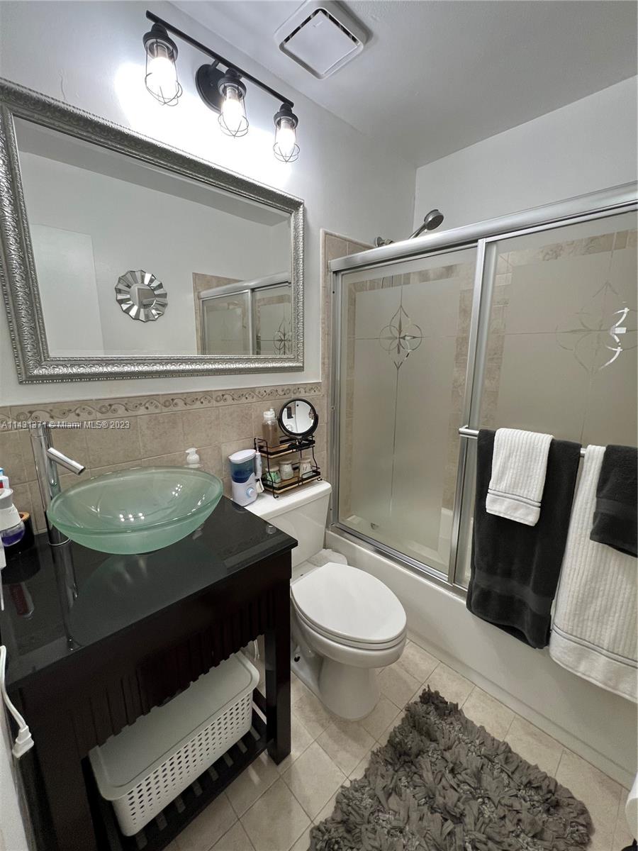 23314 Southwest 54th Way, Unit E Boca Raton, FL 33433 - Photo 58 of 69 a bathroom with a sink toilet and shower