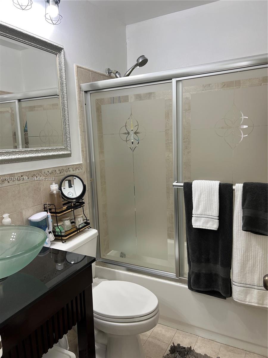 23314 Southwest 54th Way, Unit E Boca Raton, FL 33433 - Photo 59 of 69 a bathroom with a toilet a sink and shower