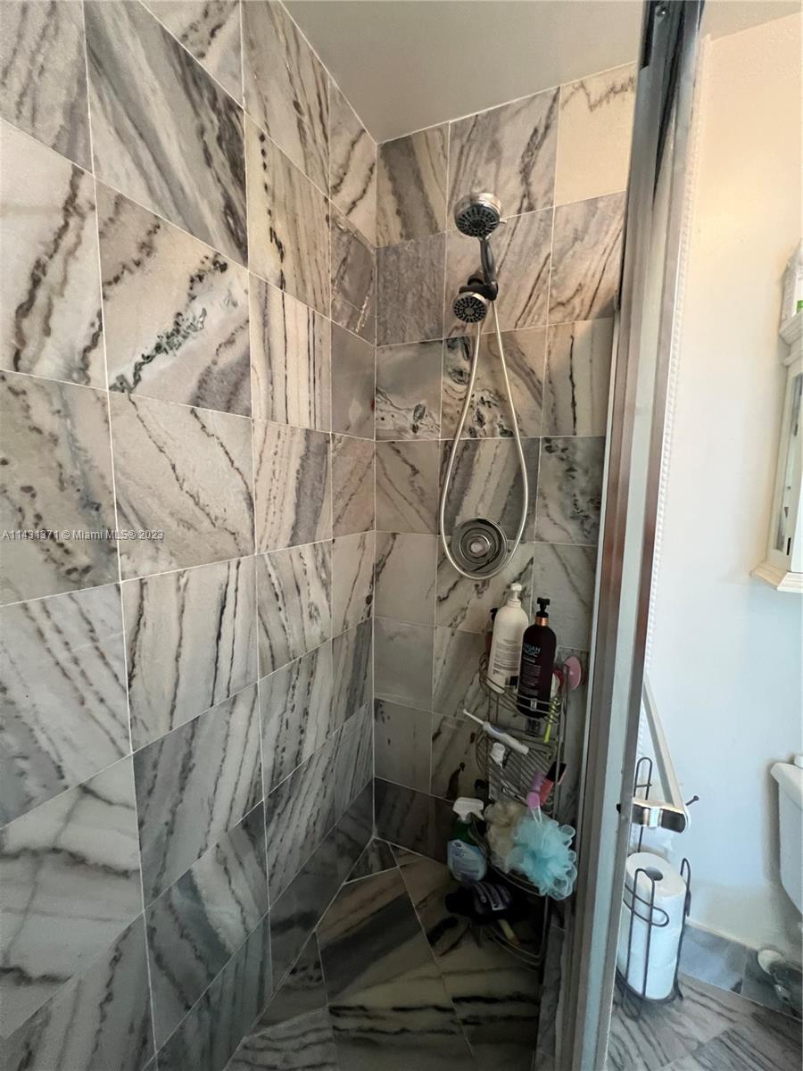 23314 Southwest 54th Way, Unit E Boca Raton, FL 33433 - Photo 63 of 69 a bathroom with a shower