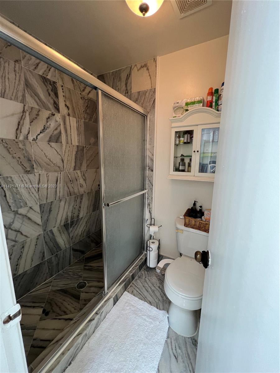 23314 Southwest 54th Way, Unit E Boca Raton, FL 33433 - Photo 64 of 69 a bathroom with a shower and a toilet