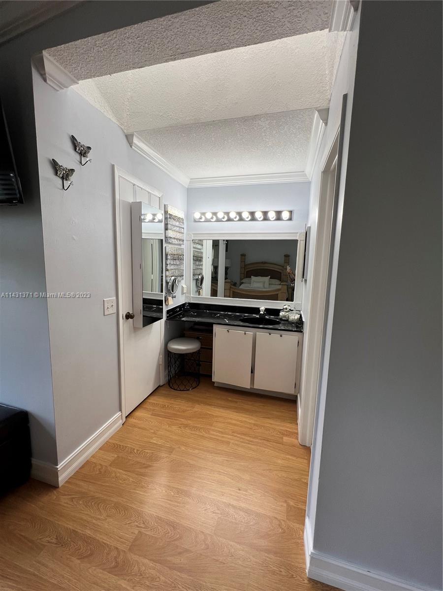 23314 Southwest 54th Way, Unit E Boca Raton, FL 33433 - Photo 65 of 69 a view of a kitchen with a sink stove cabinets and empty room