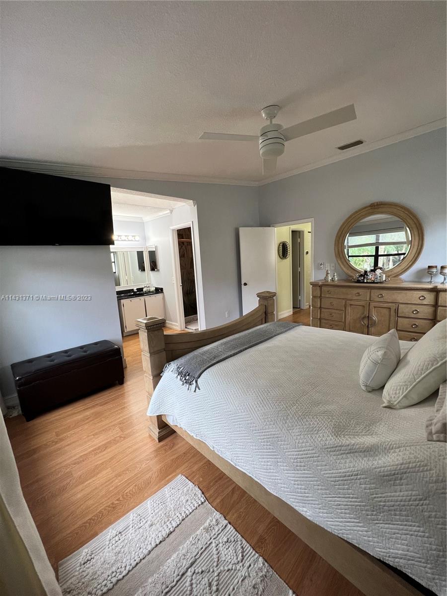 23314 Southwest 54th Way, Unit E Boca Raton, FL 33433 - Photo 66 of 69 a bedroom with a bed and a large mirror