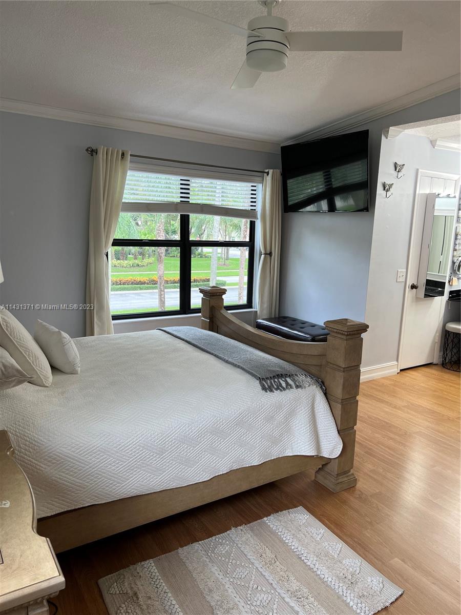 23314 Southwest 54th Way, Unit E Boca Raton, FL 33433 - Photo 68 of 69 a bed sitting in a bedroom next to a window