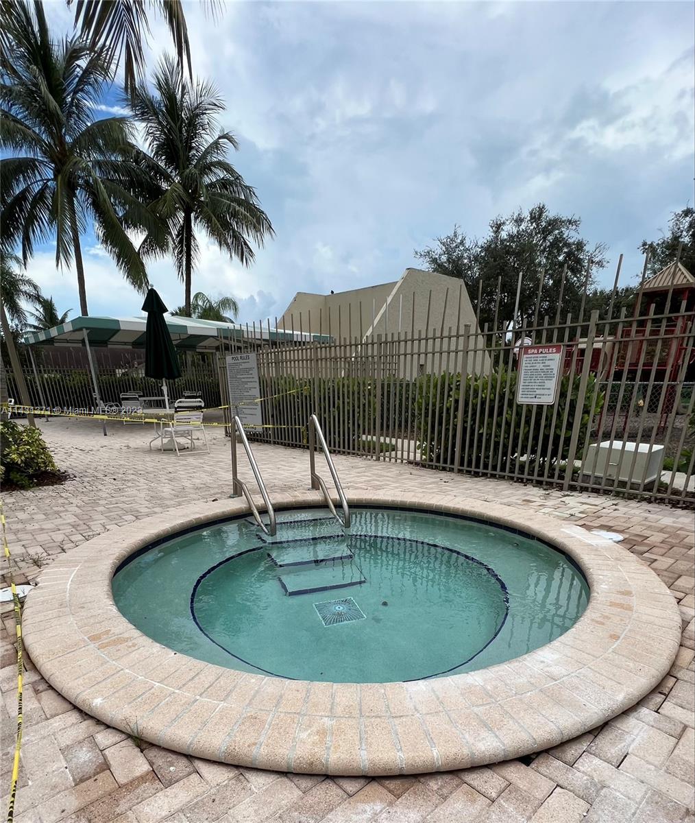 23314 Southwest 54th Way, Unit E Boca Raton, FL 33433 - Photo 7 of 69 a view of a swimming pool with a fountain and trees