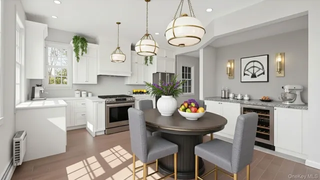 a kitchen with stainless steel appliances a dining table and chairs