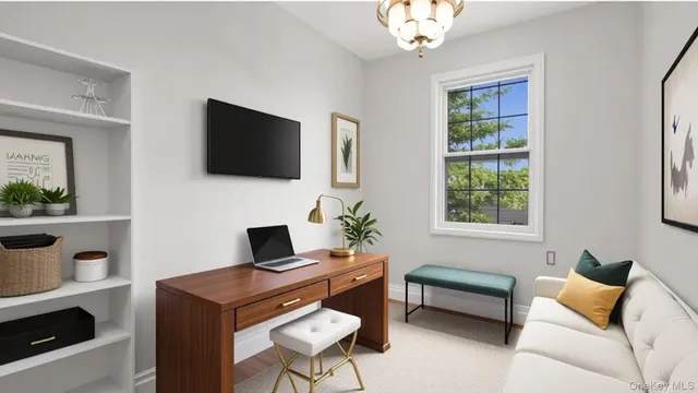 a living room with furniture a flat screen tv and a window