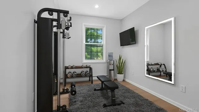 a living room with furniture a window and a flat screen tv