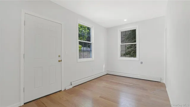 an empty room with windows and closet