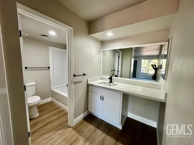 a bathroom with a sink a toilet and a large mirror