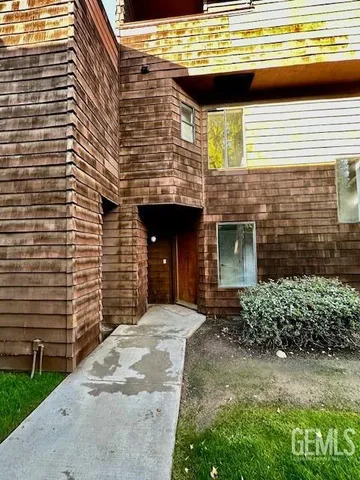 a view of front door of house with car parked