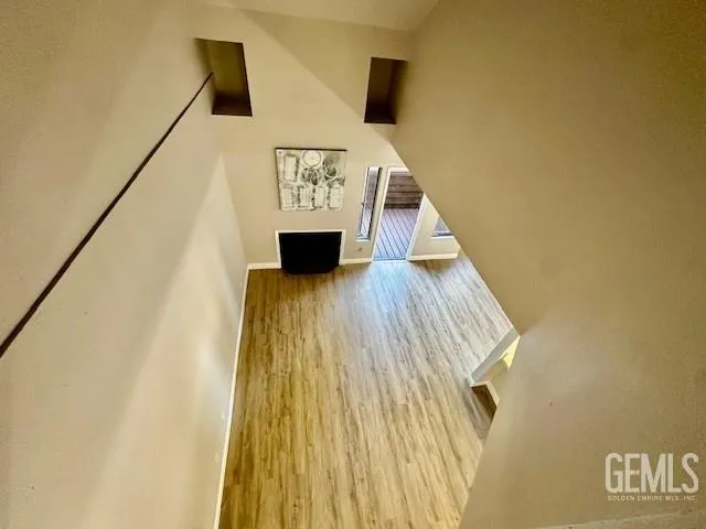 a view of entryway and hall with wooden floor
